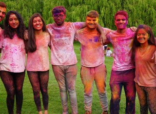 Group of students cover in colourful paint