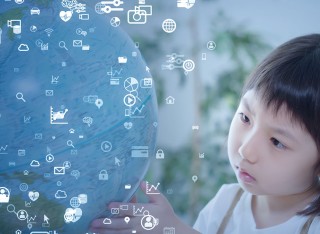 Child looking at global with lots of symbols floating around