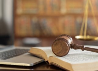 A gavel resting on a book 