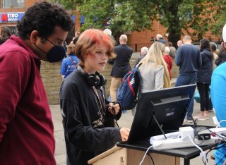 Teenager looking at GCARE tablet on Car Free Day