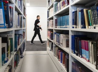 Student walking through the library