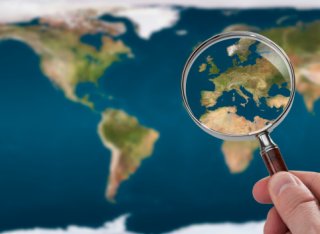 Magnifying glass over European map 