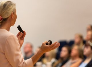 Speaker presents in lecture hall