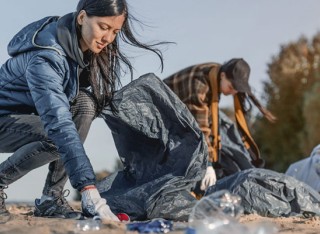 People litter picking on a beach