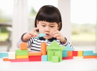 Child plays with building blocks 