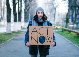 Young girl holding sign on climate change