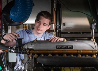 Student working on Bentley engine