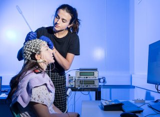 Student setting up EEG equipment