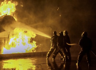 Firefighters extinguishing an industrial fire