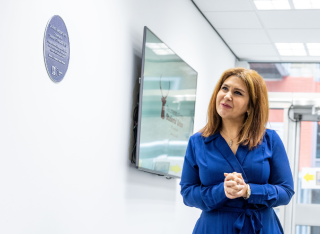 Dr Anna Vartapetiance admires her purple plaque in the Faculty of Engineering and Physical Sciences