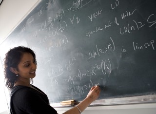 Student writing on board