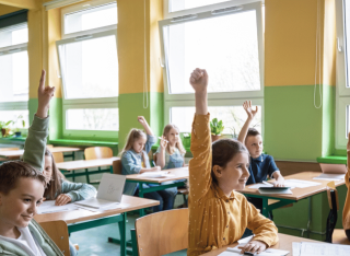 children in a classroom with open windows