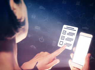 stock photo of a woman scrolling a smartphone and voting at the same time