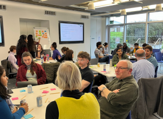 Group of staff discussing at Sustainability Assembly