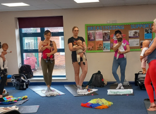 Women and babies taking part in yoga