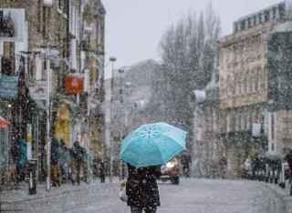 A person walking with an umbrella on a rainy day