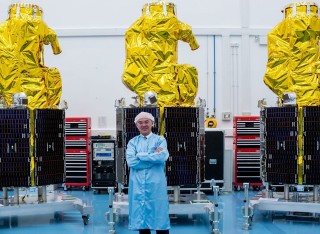 Professor Sir Martin Sweeting with satellites at Surrey Satellite Technology Ltd