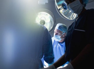 Man performs surgery in theatre