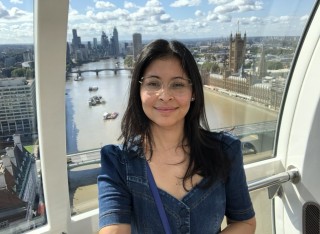 Larissa takes a selfie in the London Eye with the Thames visible behind her.