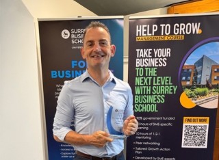 Delegate holding an award at Surrey Business School Celebrating Partners event on 24 June 2026