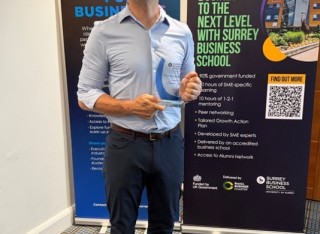 Delegate holding an award at Surrey Business School Celebrating Partners event on 24 June 2026