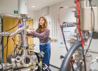 Photograph of Dr Ella Schneider in Surrey's Ion Beam Centre