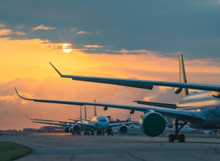 planes lined up at an airport runway