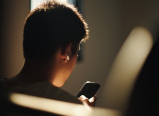 A person scrolls on their phone