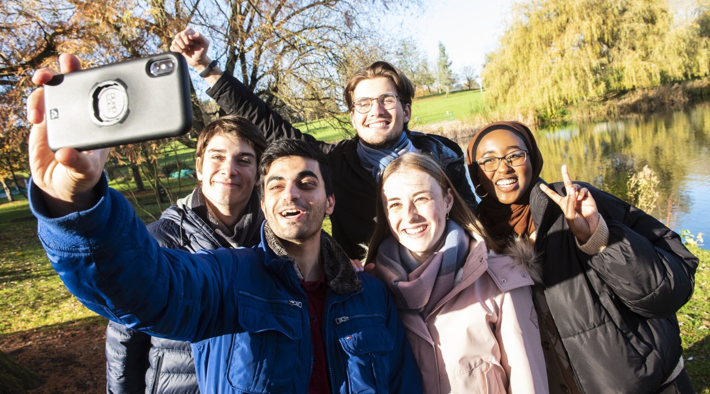 a group of students taking a selfie on campus