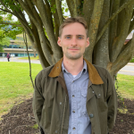 Photo of Douglas standing by a tree