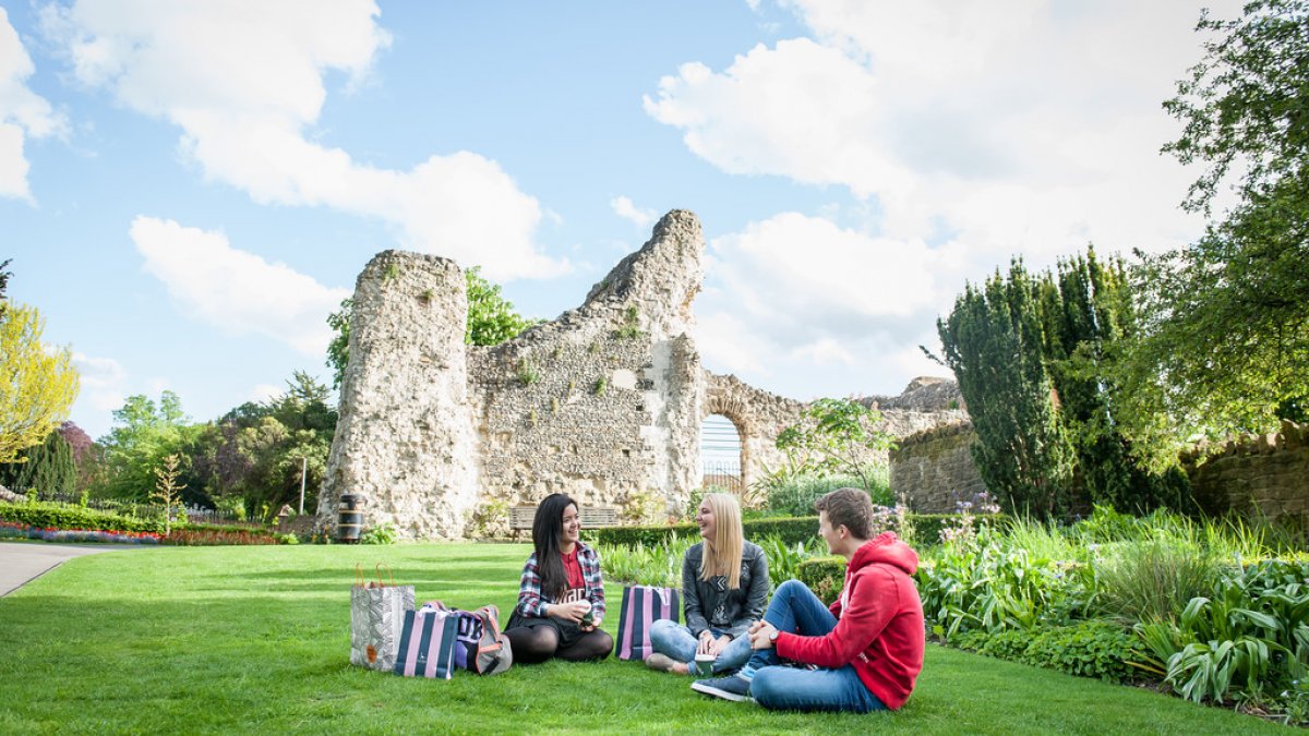 Students sitting outside near Guildford Castle