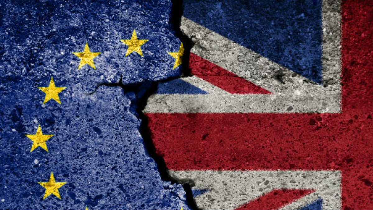 The EU flag and Great Britain flag next to each other breaking apart