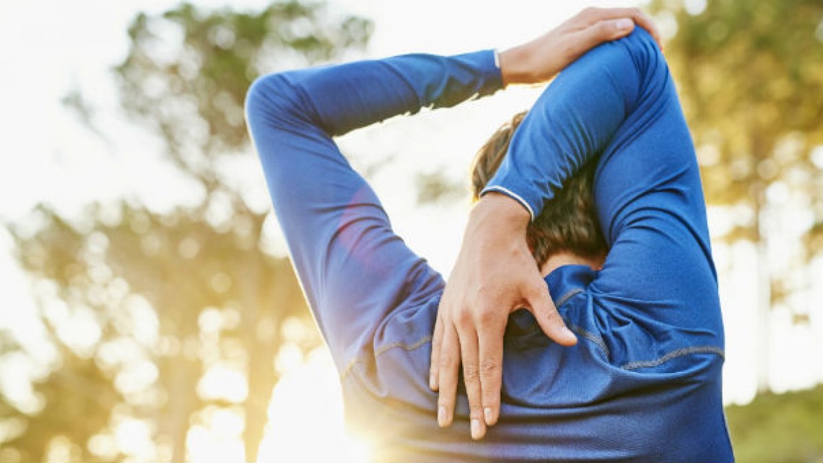 A man stretching muscles before doing exercise
