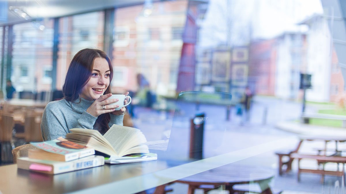 Student drinking coffee in Heart and Soul coffee shop