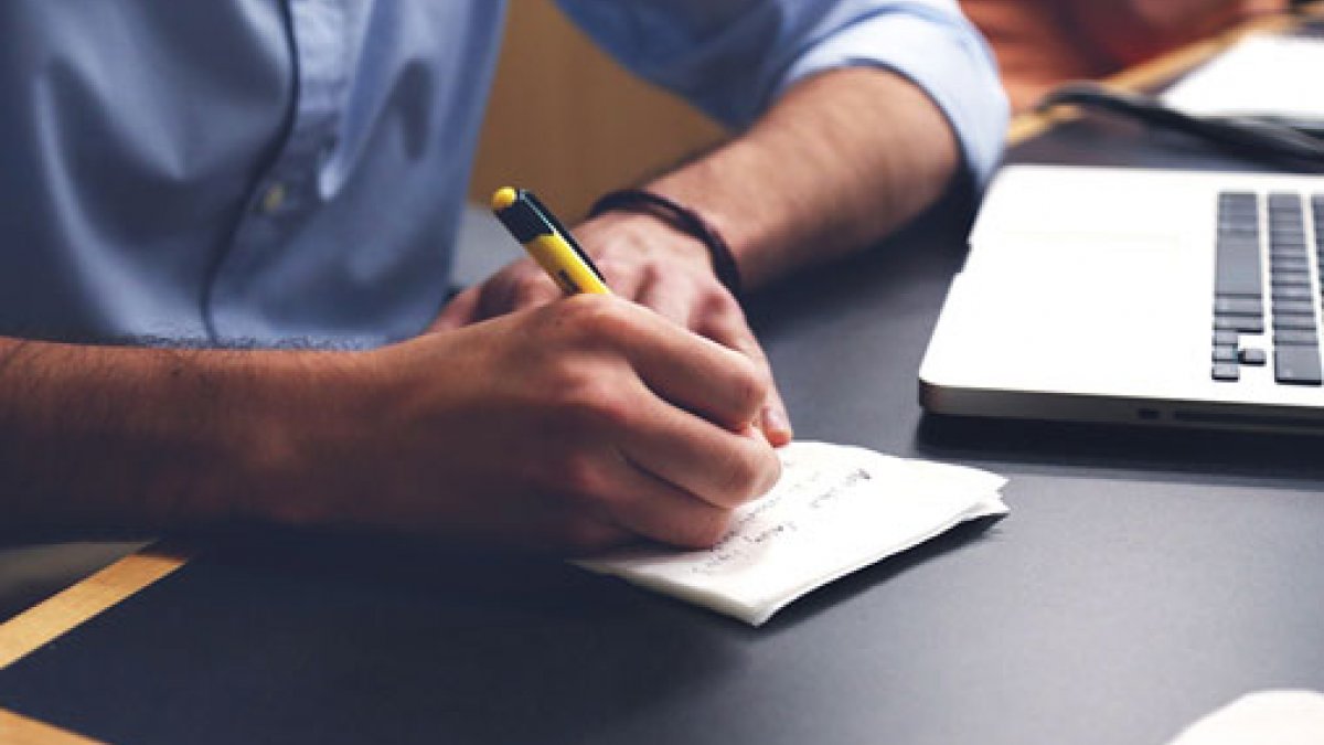 Man writing at a desk