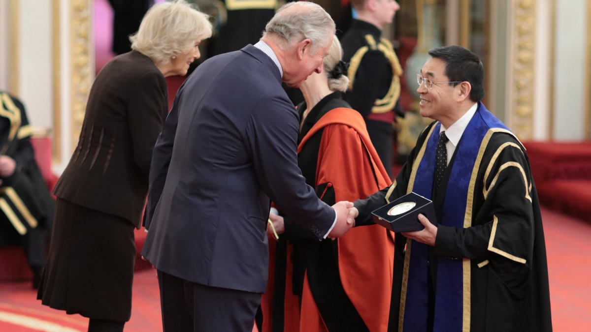 Max Lu and Sue Lanham-New being award the Queens Anniversary award at Buckingham Palace