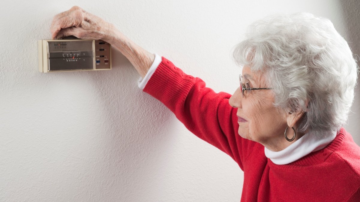Woman turning up heating