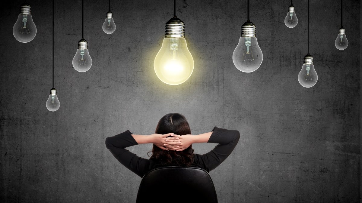 Woman underneath lightbulbs