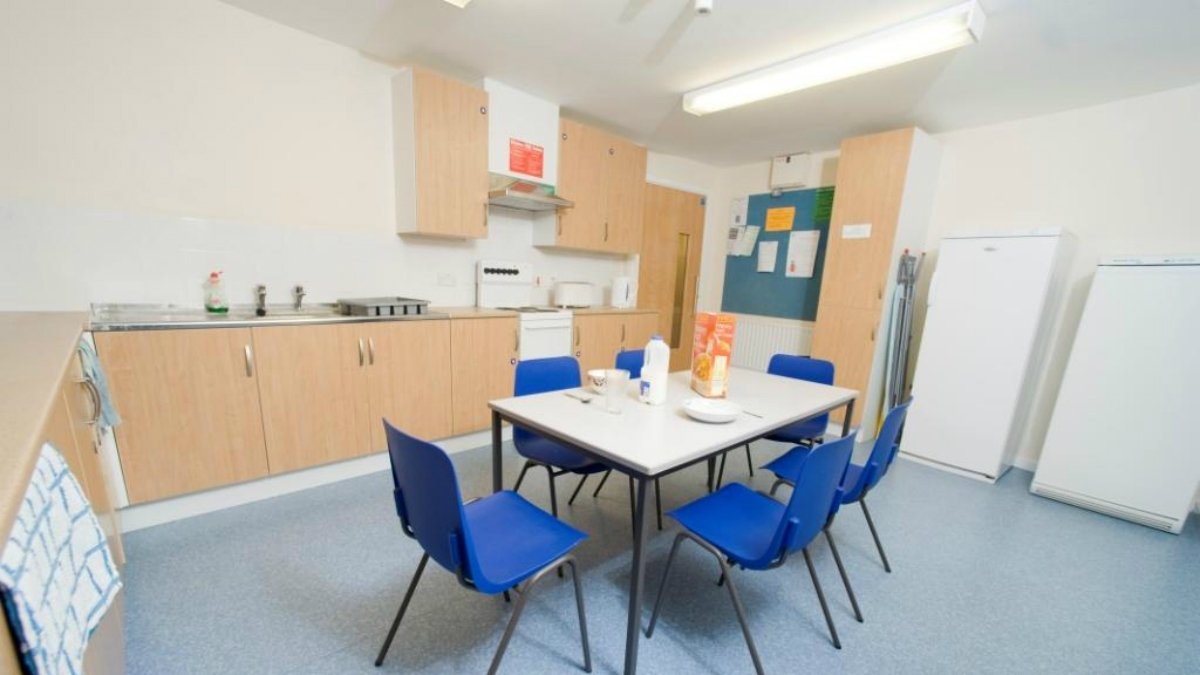 University accommodation kitchen with table and chairs in the centre