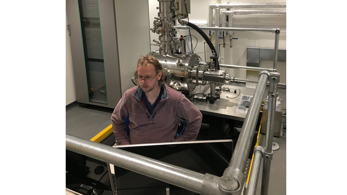 David Cox, a focussed ion beam expert from the University of Surrey and the National Physical Laboratory performing commissioning tests at the console of the new SIMPLE tool in its new laboratory at Surrey.