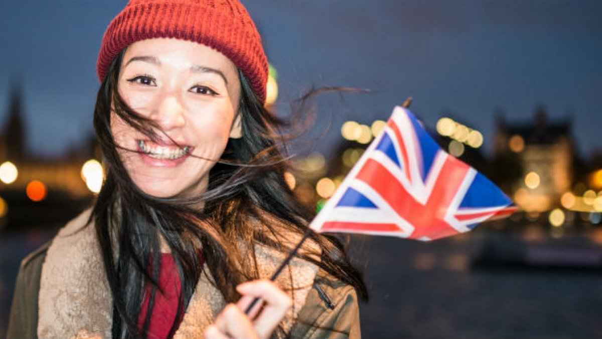 Asian woman holding union flag