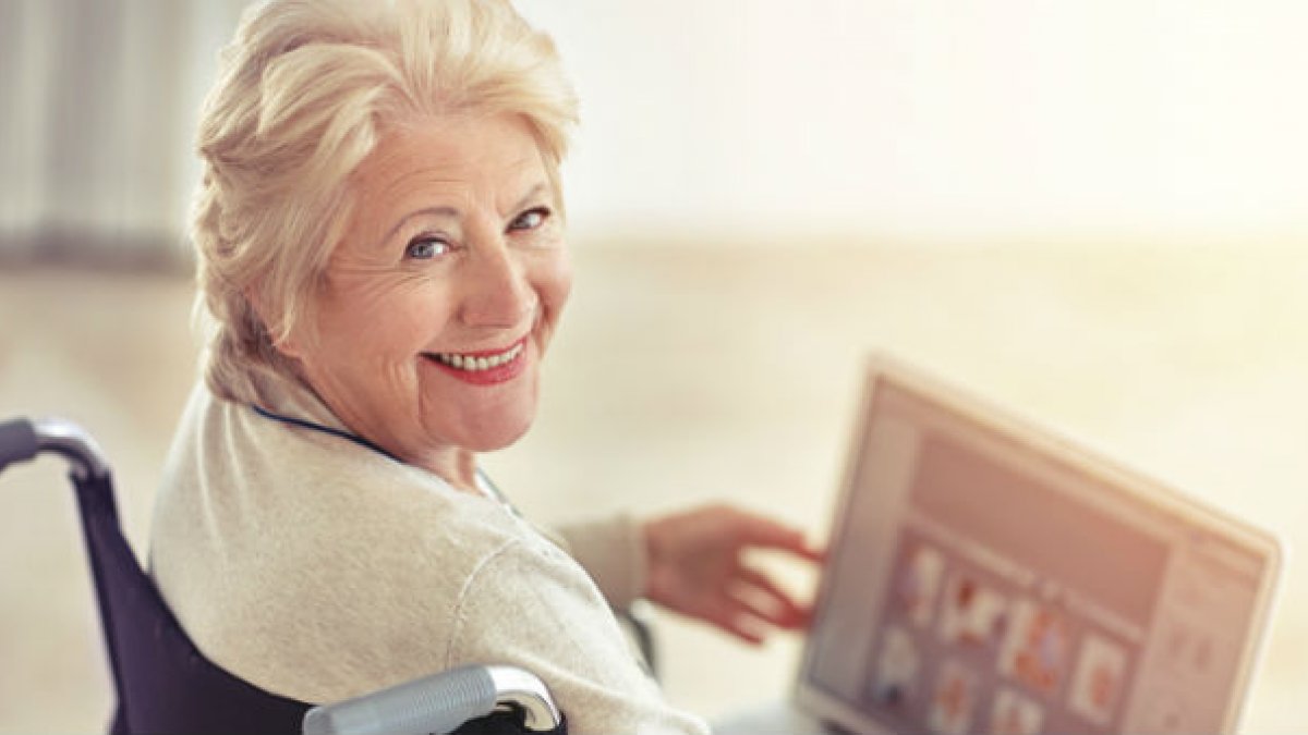 Lady in wheelchair reading magazine