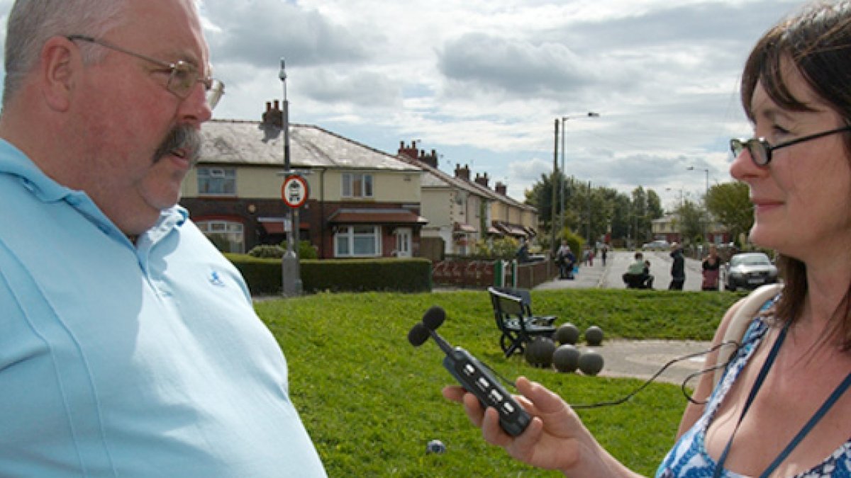 Female journalist interviewing man
