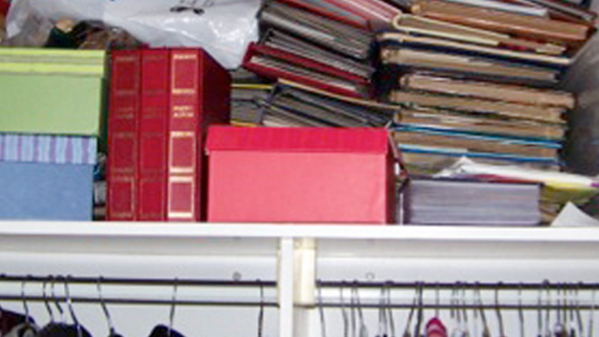 Rows of boxes and books on shelf
