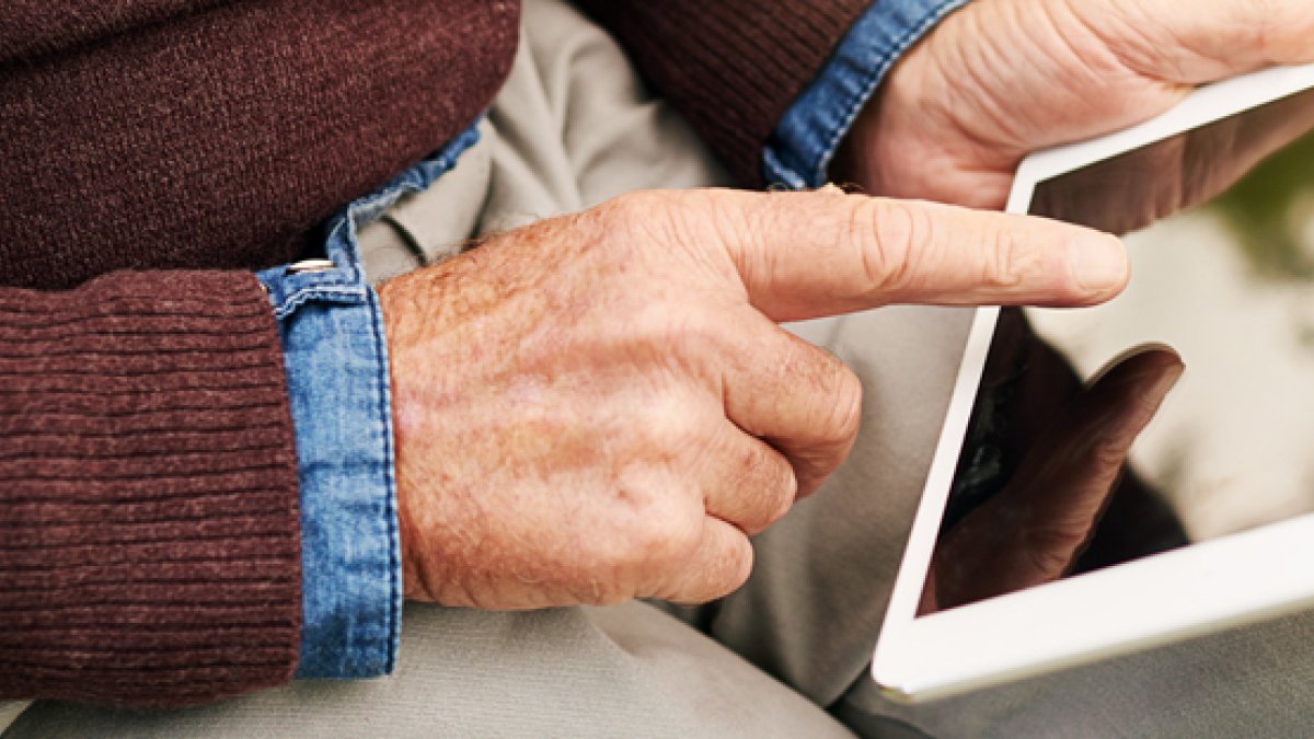 Elderly man using a tablet