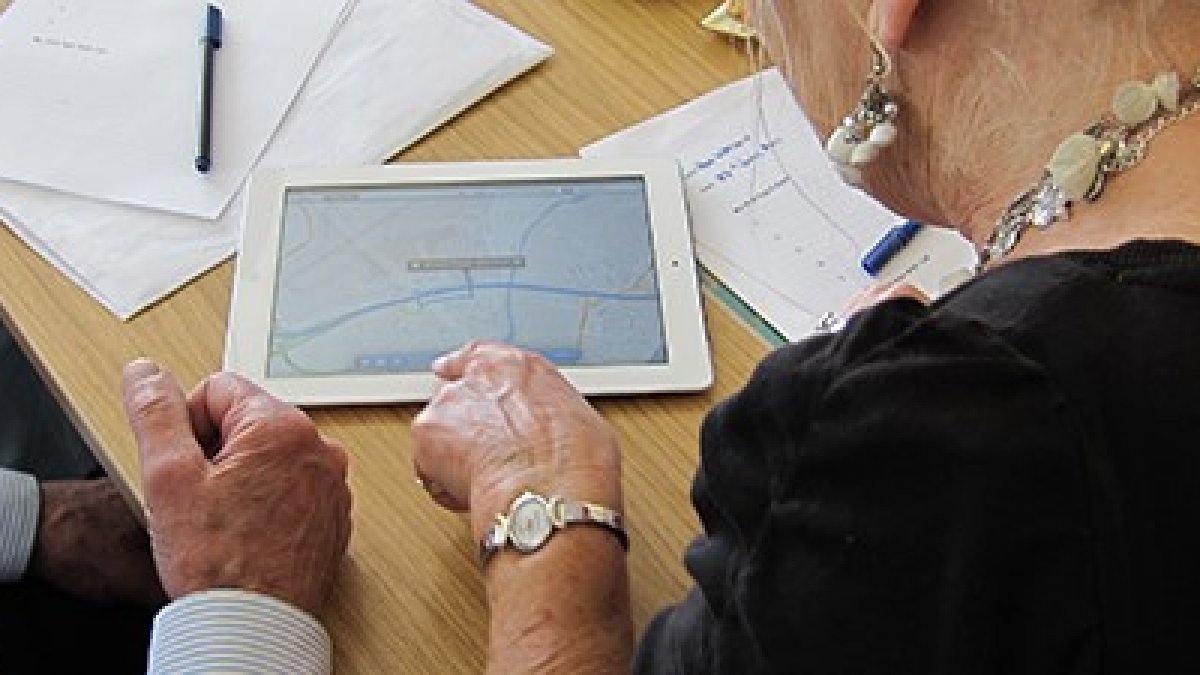 Two elderly people using a tablet