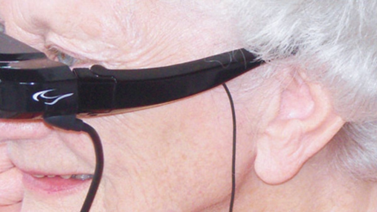 Elderly woman wearing electronic visor