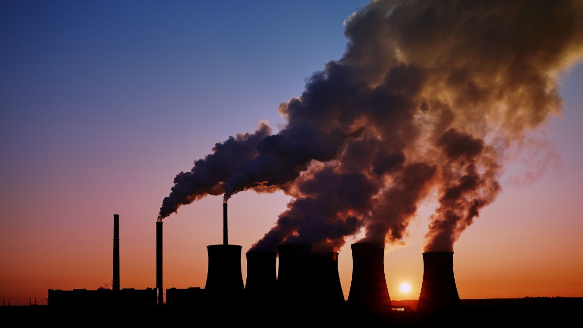 Power station with large amounts of smoke pouring from the top