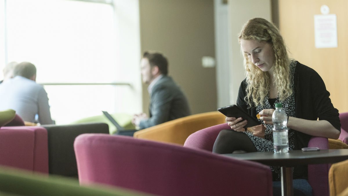 Woman sat eating in cafe