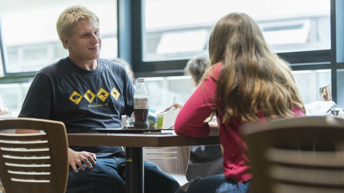 People sat eating and talking in cafe